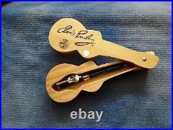 Elvis sun glasses, wood guitar case and pen, playing cards, tin, book and more